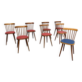 Eight Baumann chairs with coloured seats.