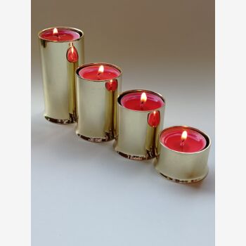 A set of four metal candlesticks from the 1980s