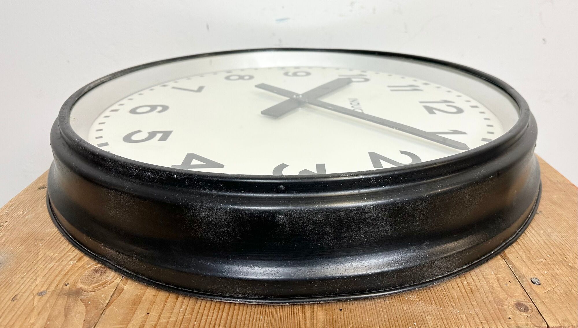 Black swiss industrial wall clock from inducta, 1960s