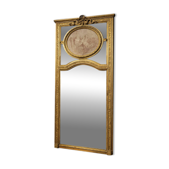 Very large mirror with mouldings, richly carved and gilded, in the Louis XVI style.