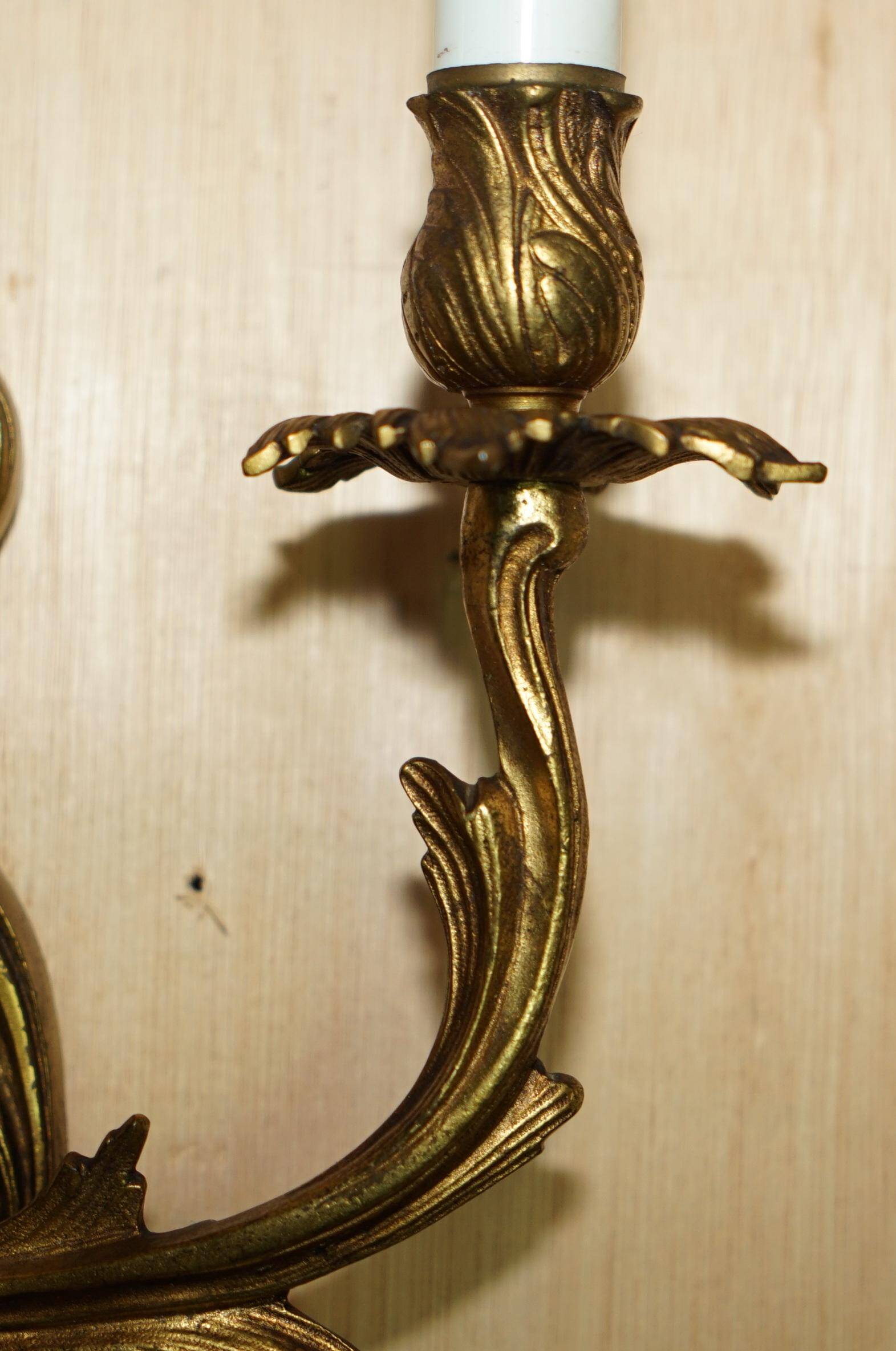 Pair of antique French wall sconces, gilded and bronzed, from the 1920s.