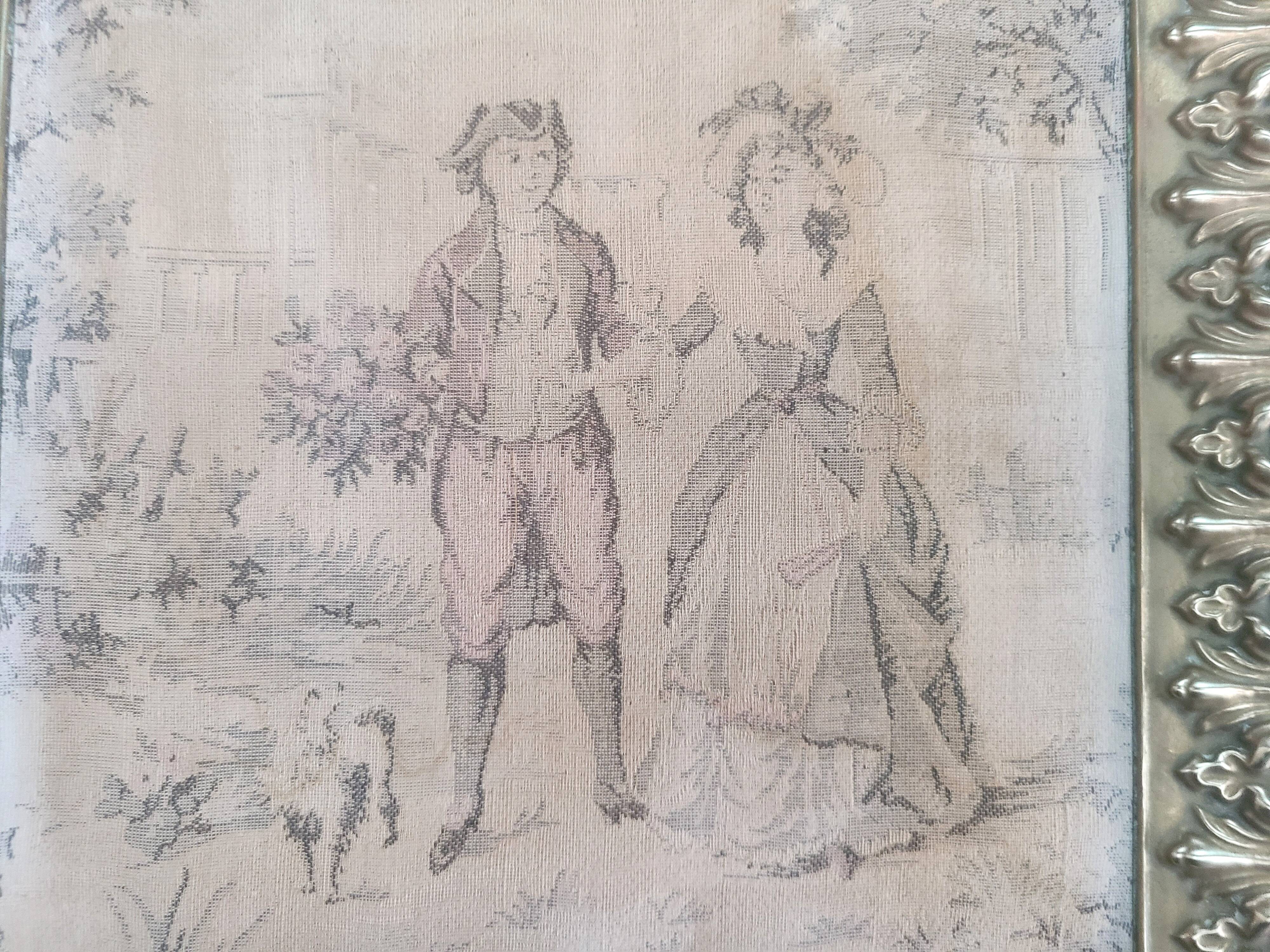 Antique tapestries framed in repoussé brass.