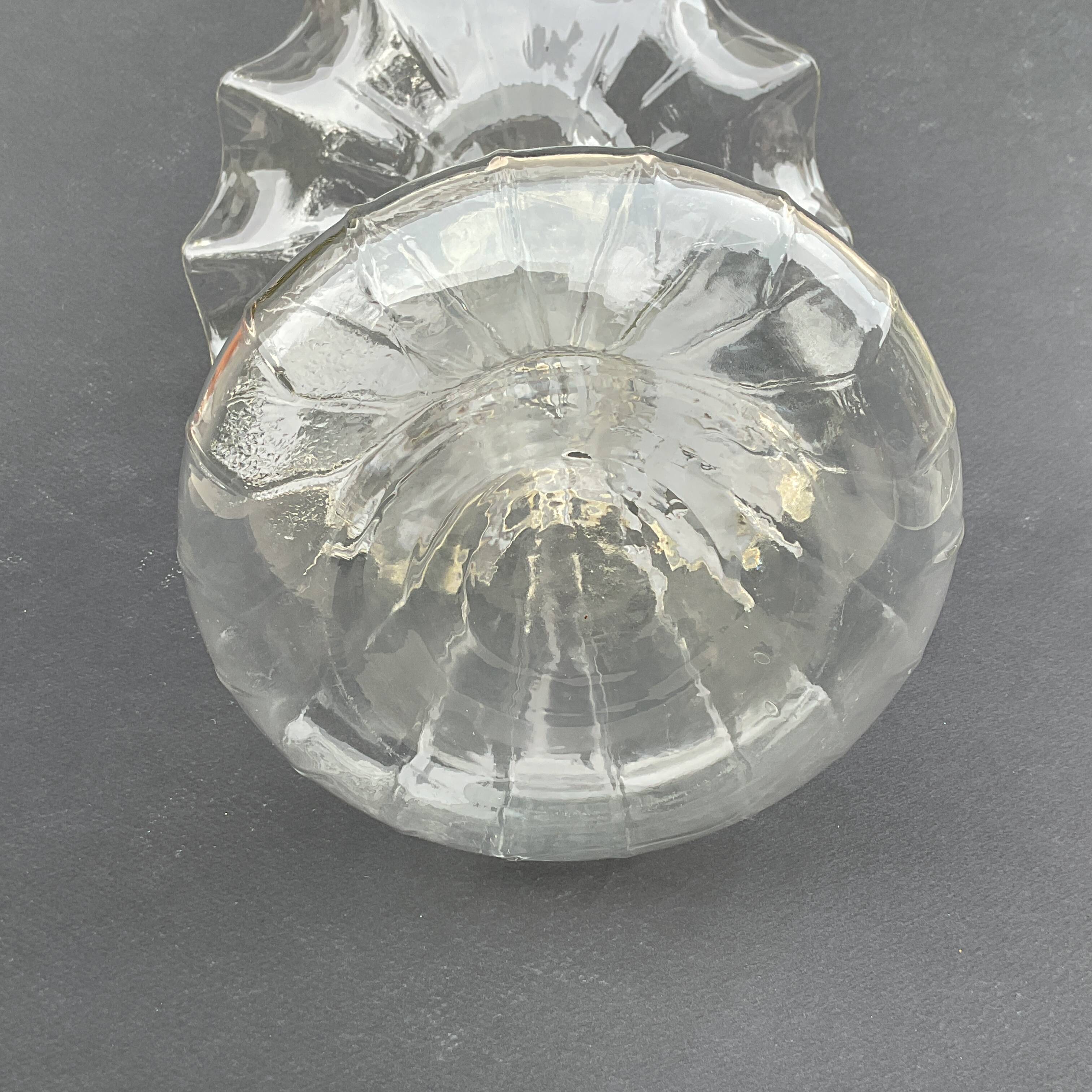 Vintage transparent glass vase in flower shape.