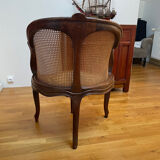 Cane seat armchair from the 19th century in the Louis XV style, known as "couillard".
