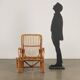 Vintage wicker armchair with magazine rack, Italy, 1960s