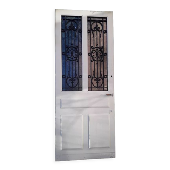 Etrance door, oak, glazed, cast iron grilles 1925