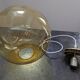 Old large and imposing thick glass globe with a bubbled amber colour, vintage.