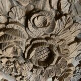 wooden painting with carved floral motif - note a restoration on the left side at the bottom.