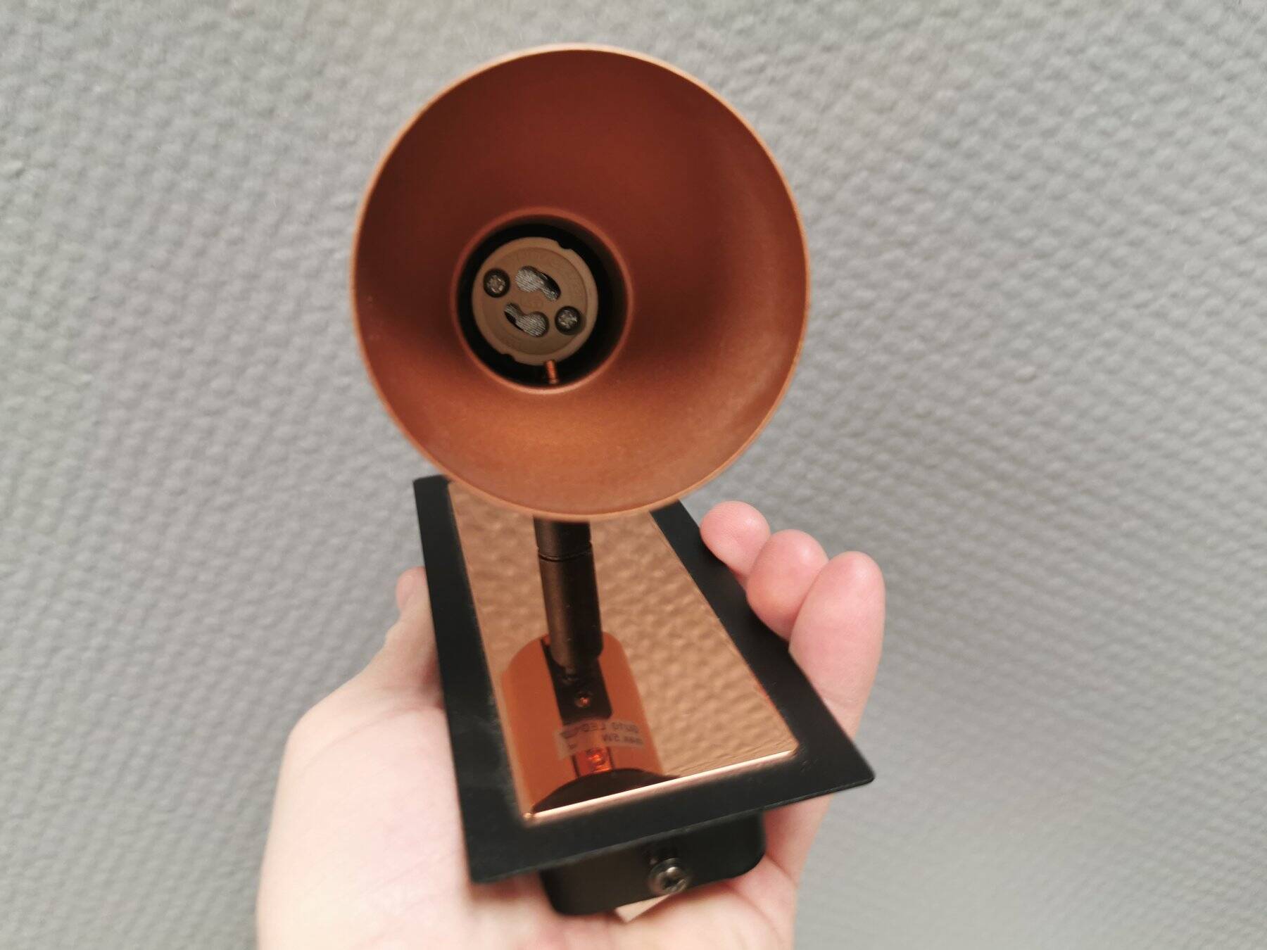 A pair of wall lamps from Eglo, in copper color and black.