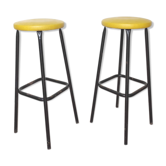 Pair of black metal bar stools and yellow imitation leather seat