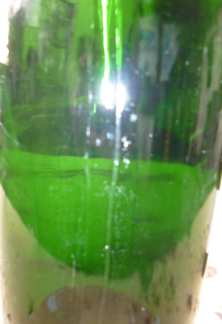 Green blown glass bottle of 58 cm.