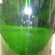 Green blown glass bottle of 58 cm.