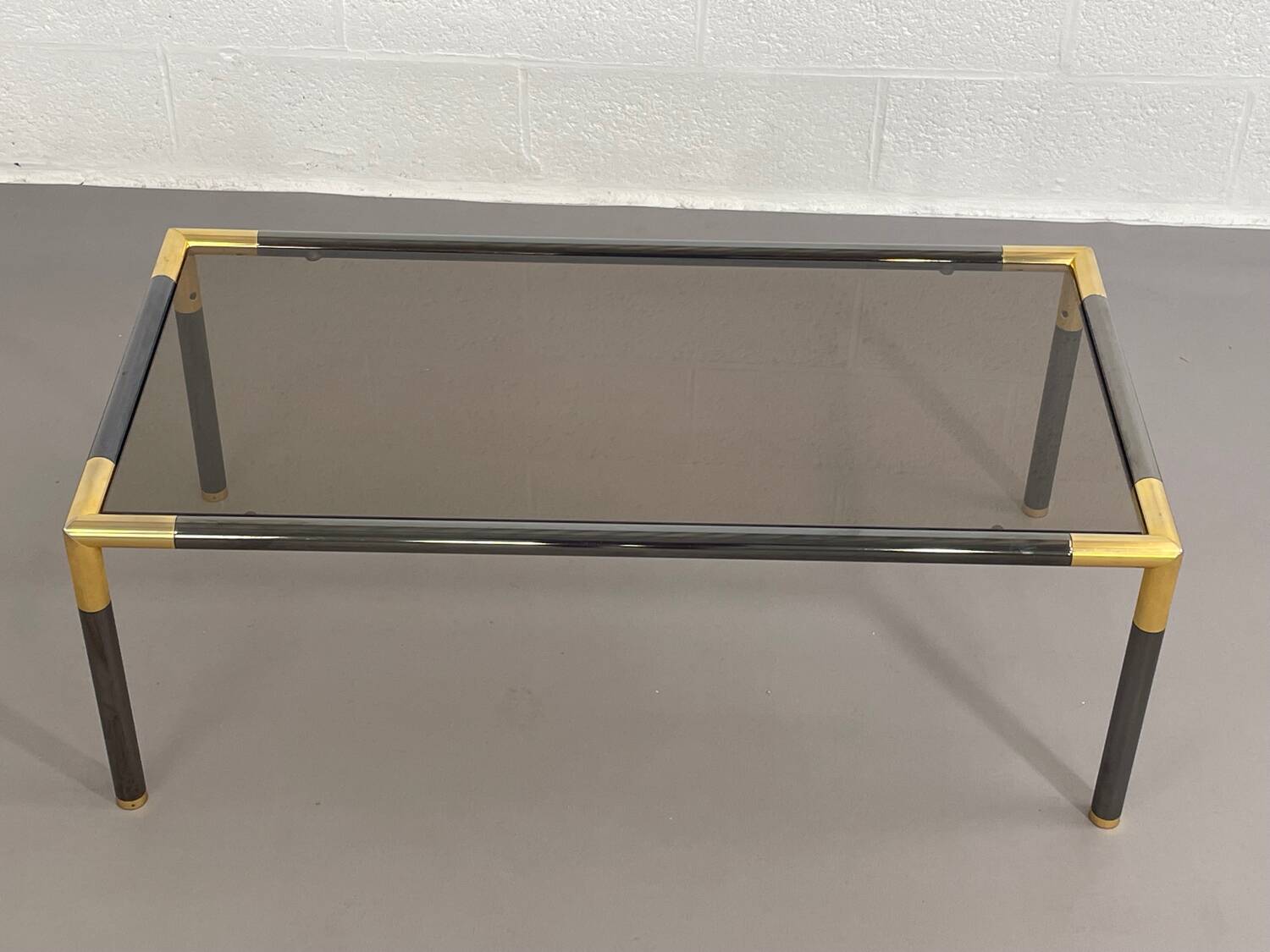 Gunmetal gold metal and smoked glass coffee table from the 70s