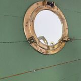 Porthole mirror in gilded brass