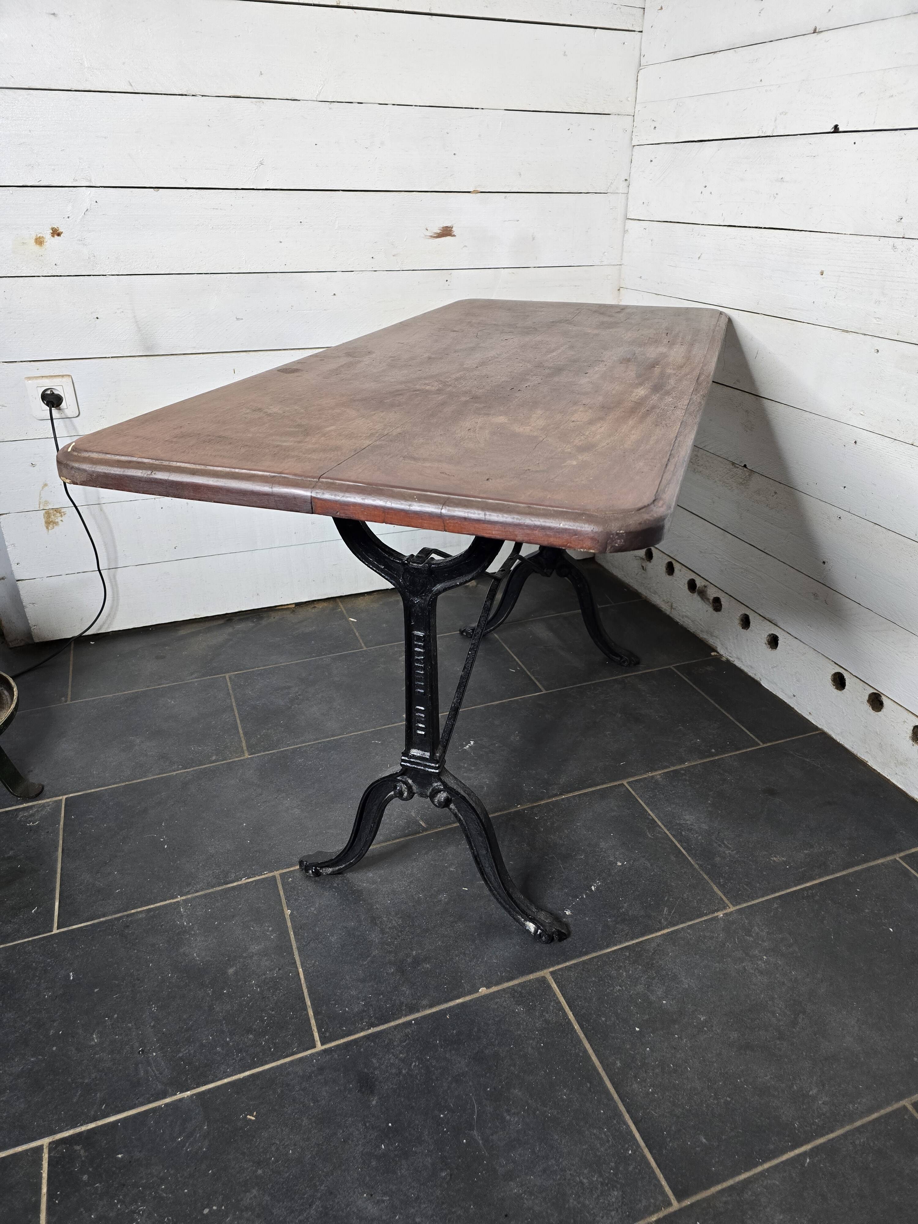 Bistro table with cast iron legs and solid wood top