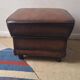 Vintage ottoman / pouffe in chestnut brown leather