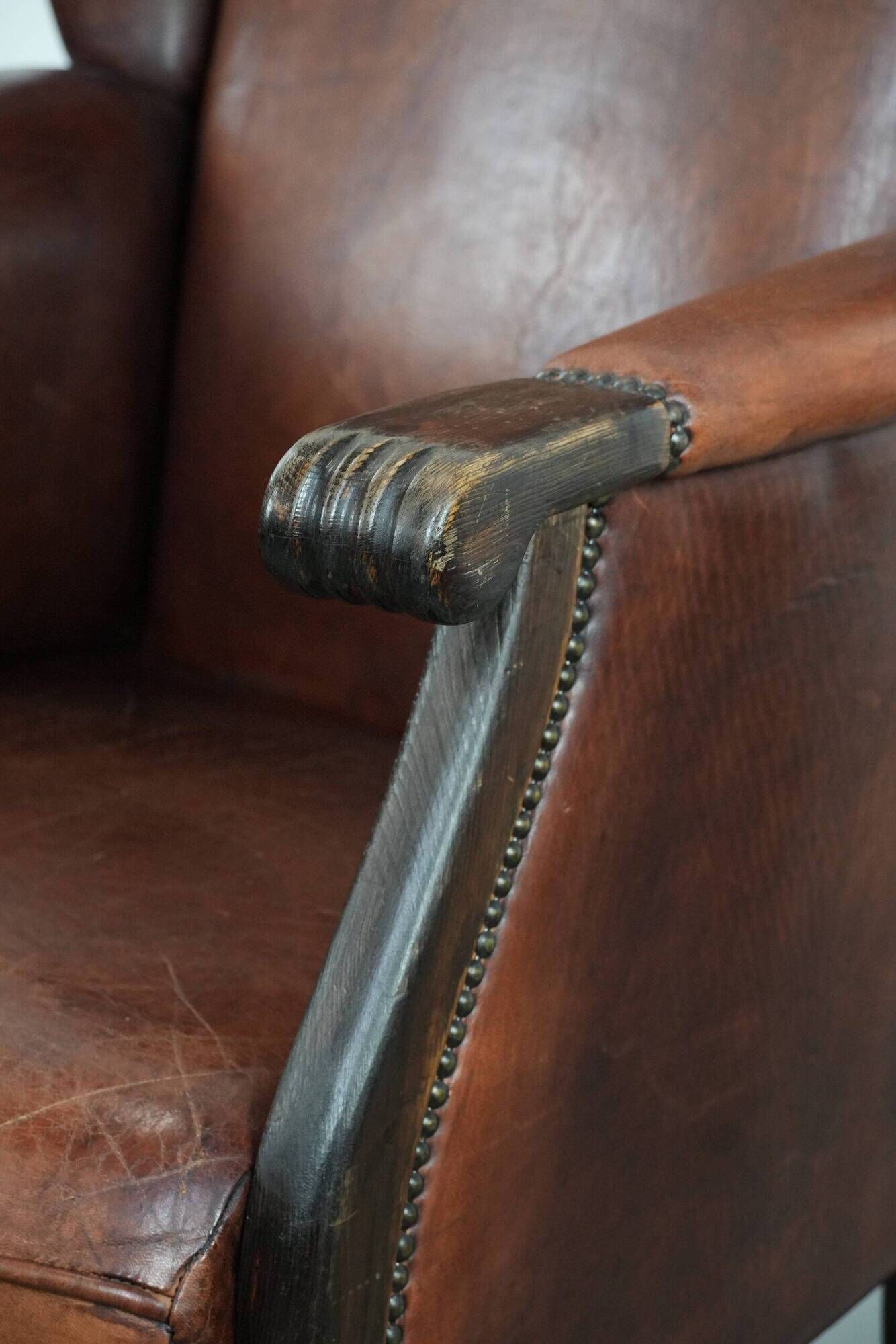 Classic vintage wingback chair in sheepskin and wood