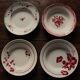 A set of 4 mismatched Art Deco red blue soup plates