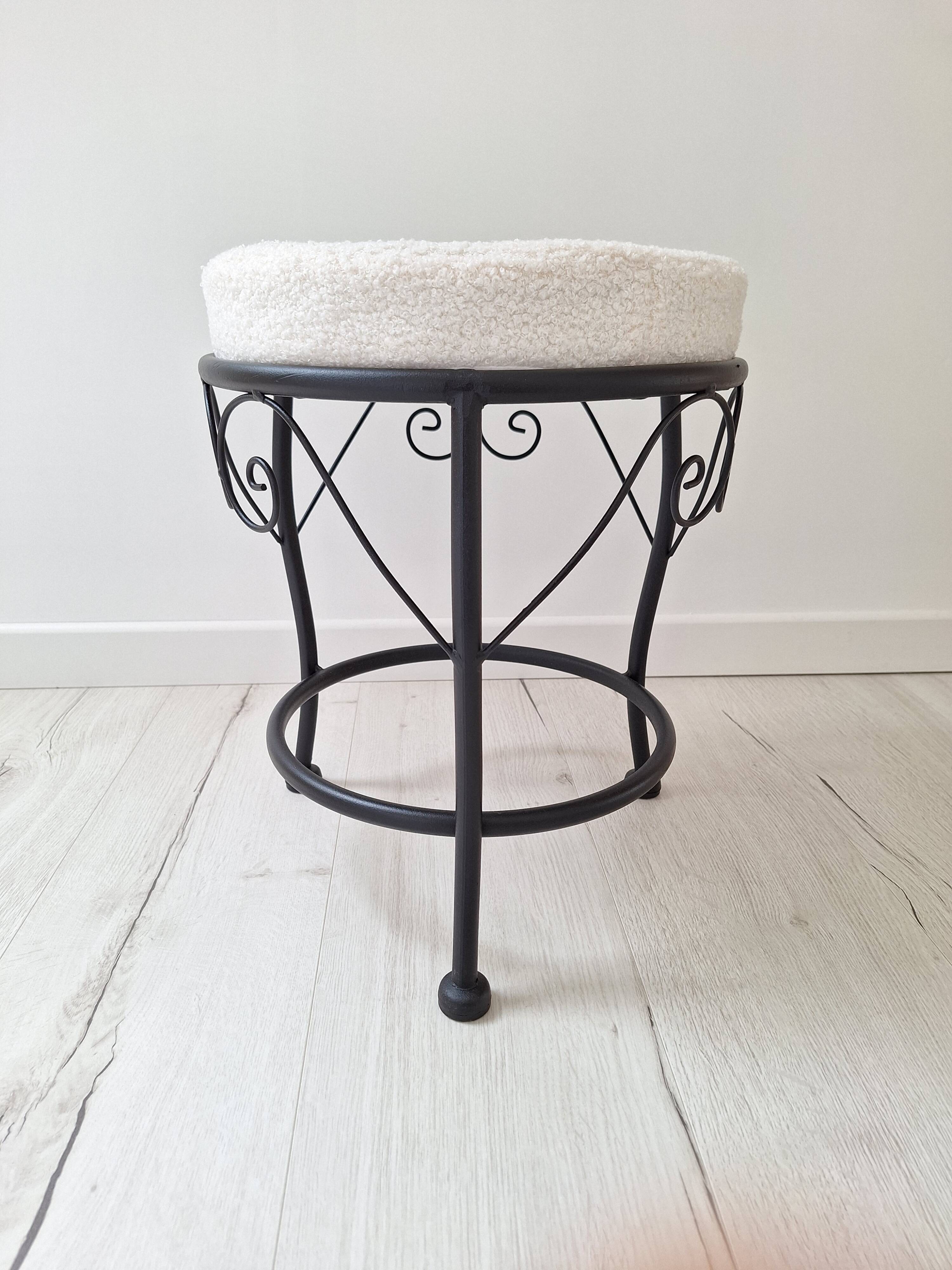 Black iron stool/pouf with its boucle fabric cushion.