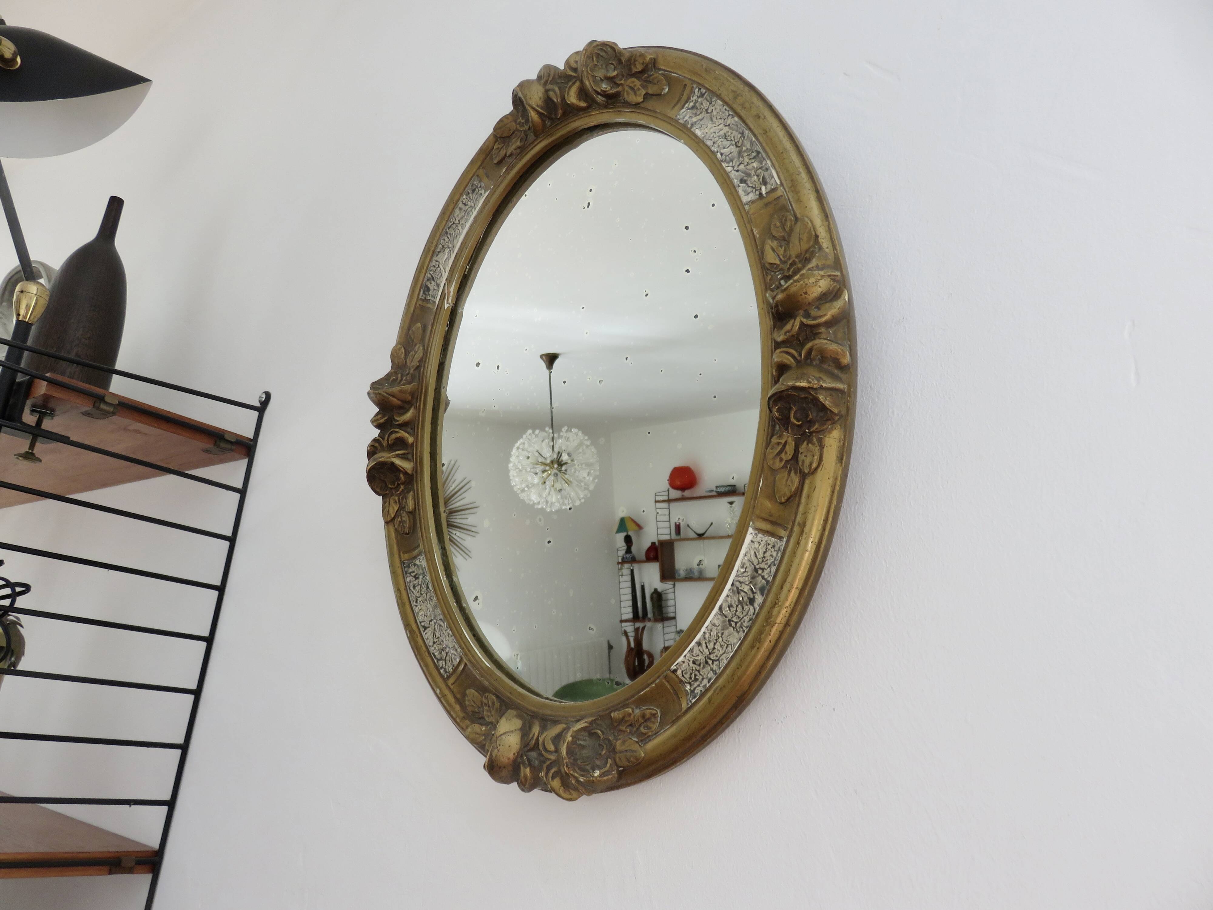 Oval wall mirror, golden floral pattern in stucco and wood, late 19th century