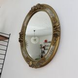 Oval wall mirror, golden floral pattern in stucco and wood, late 19th century