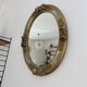 Oval wall mirror, golden floral pattern in stucco and wood, late 19th century