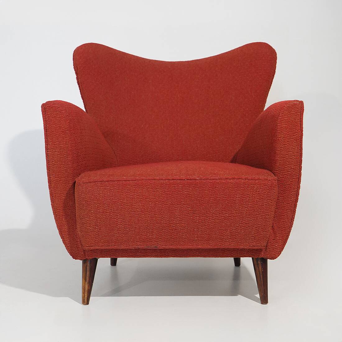 Pair of red armchairs with cone-shaped feet, 1950s