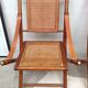 Pair of folding chairs in bamboo and caning, leather and brass