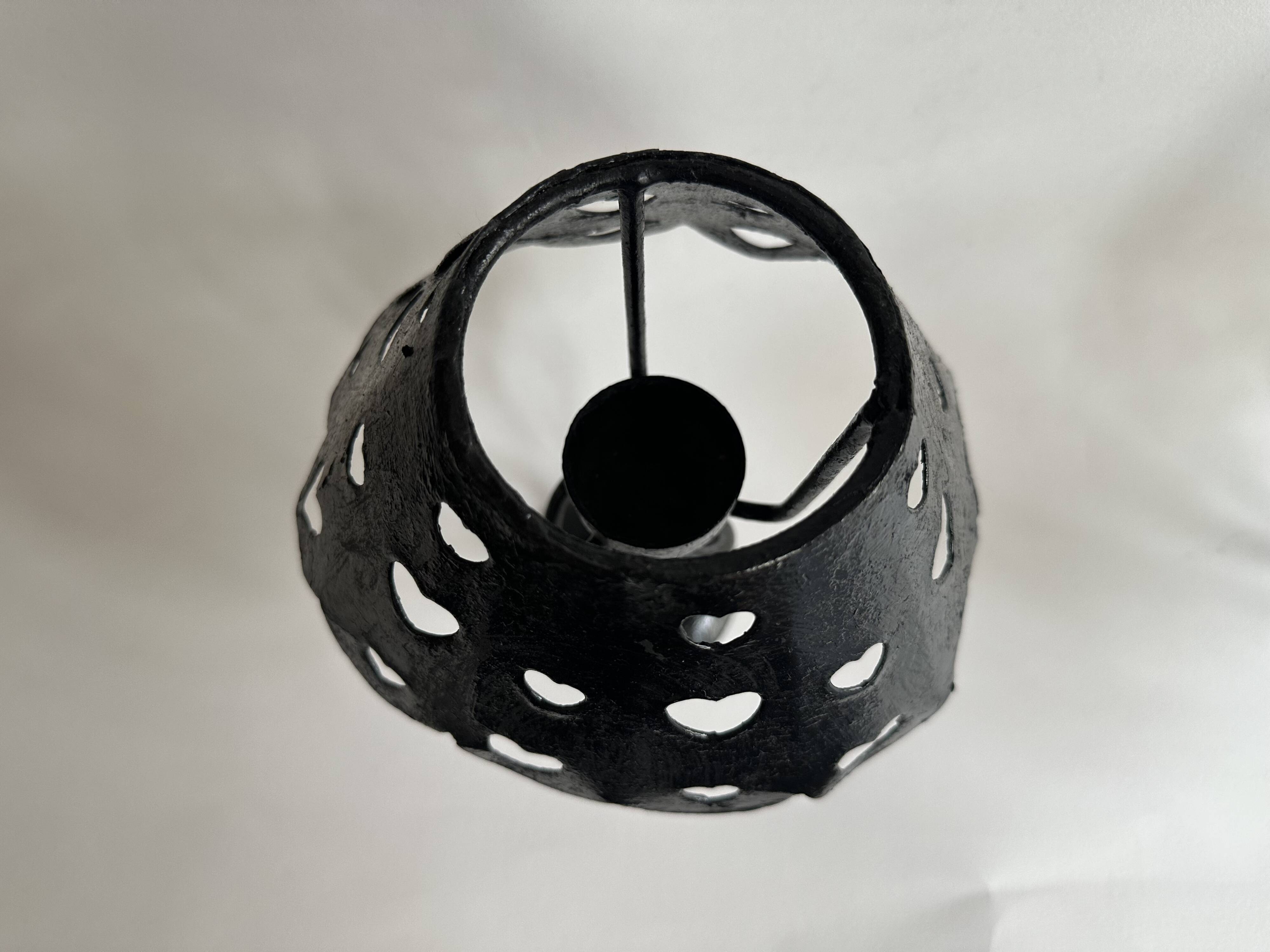 Pair of black wrought iron lanterns with heart patterns, romantic style.
