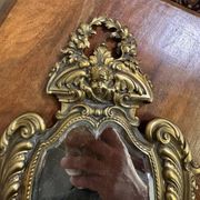 Mirror in the Louis XV Rocaille style in gilded bronze.