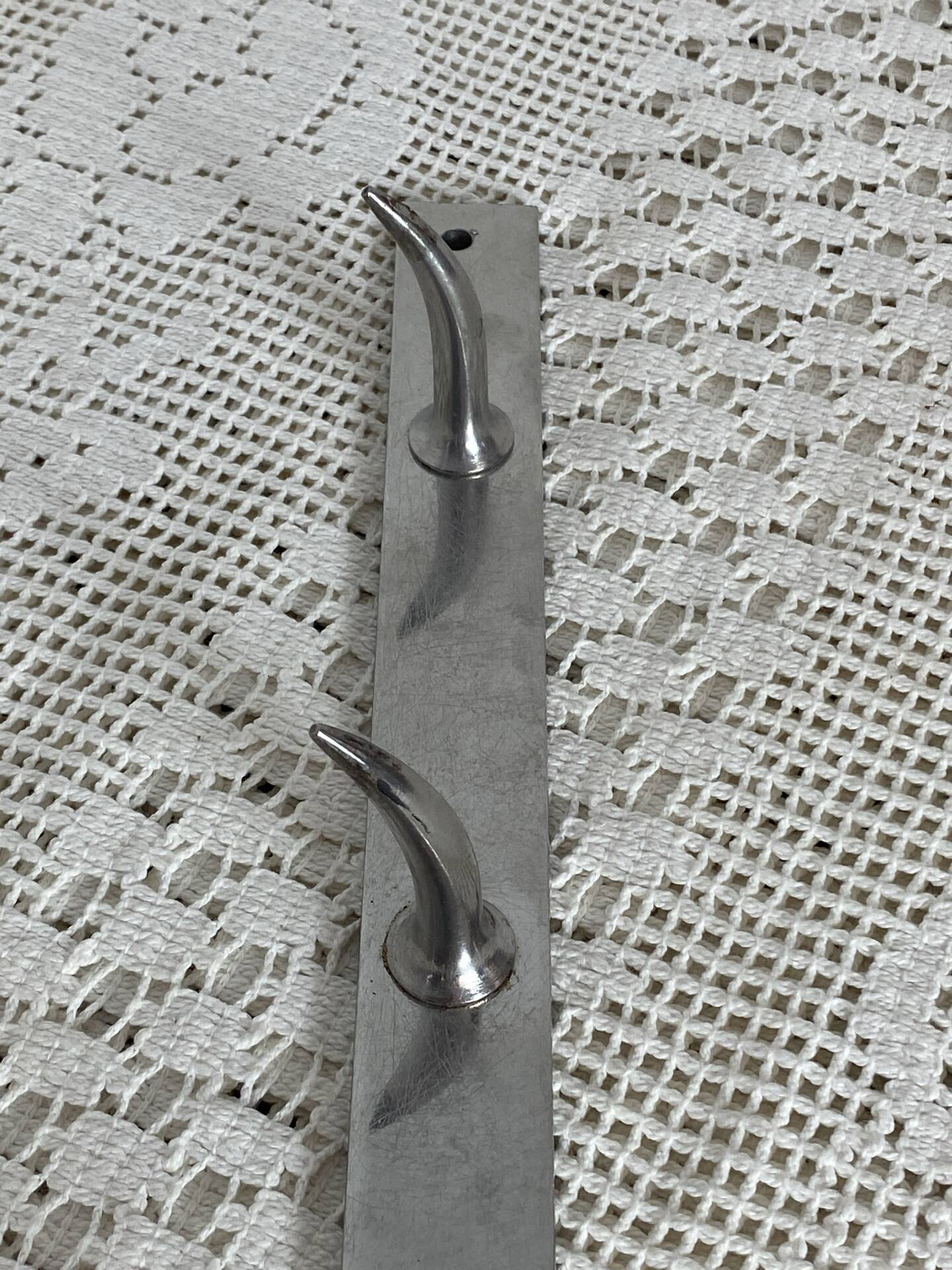Stainless steel butcher's hook, known as a "wolf tooth bar."