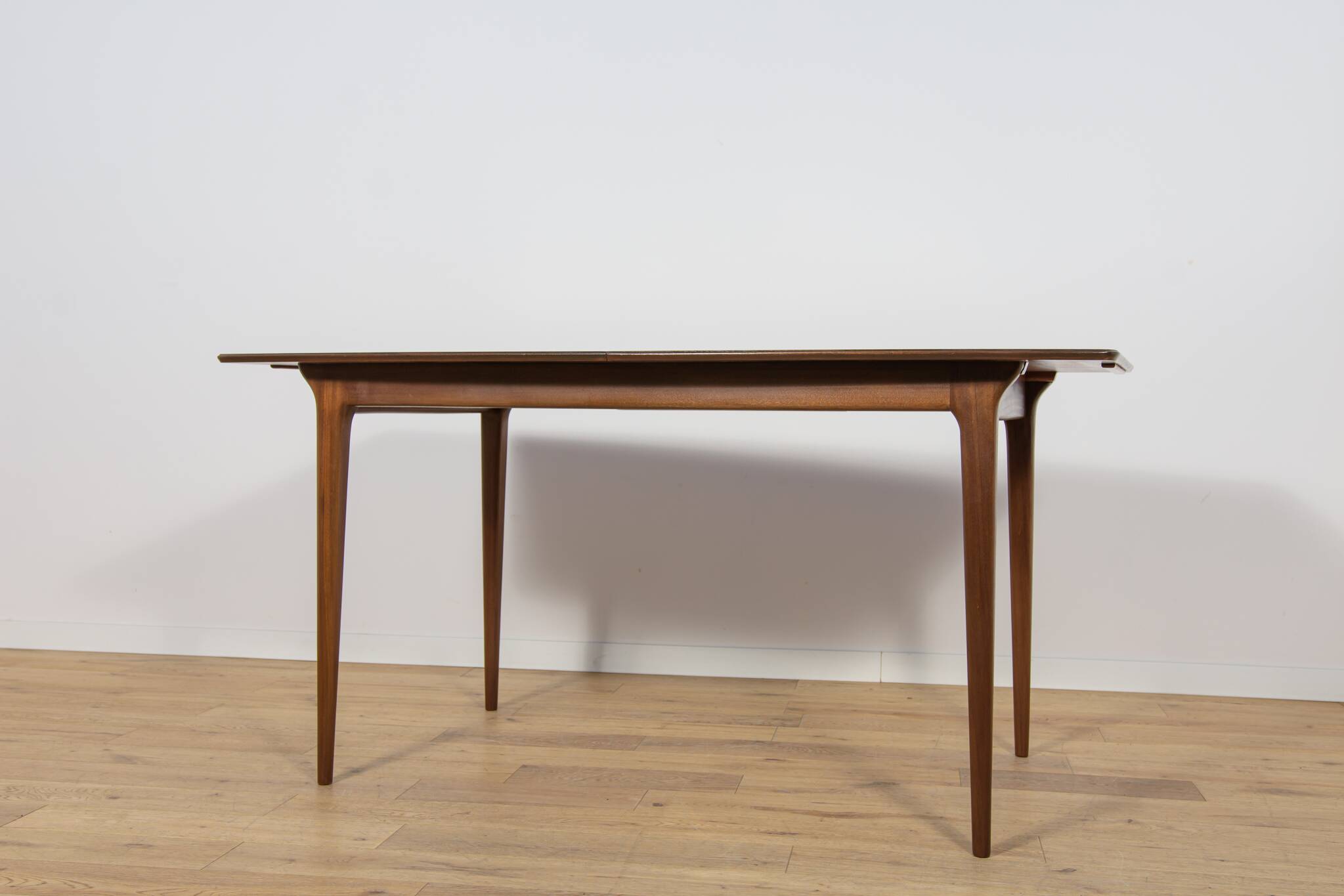 Extendable teak dining table in Mid-Century style from McIntosh, UK.