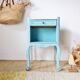 Small vintage bedside table in azure blue patina.