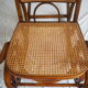 Rocking-chair en bois teinté et assise cannée