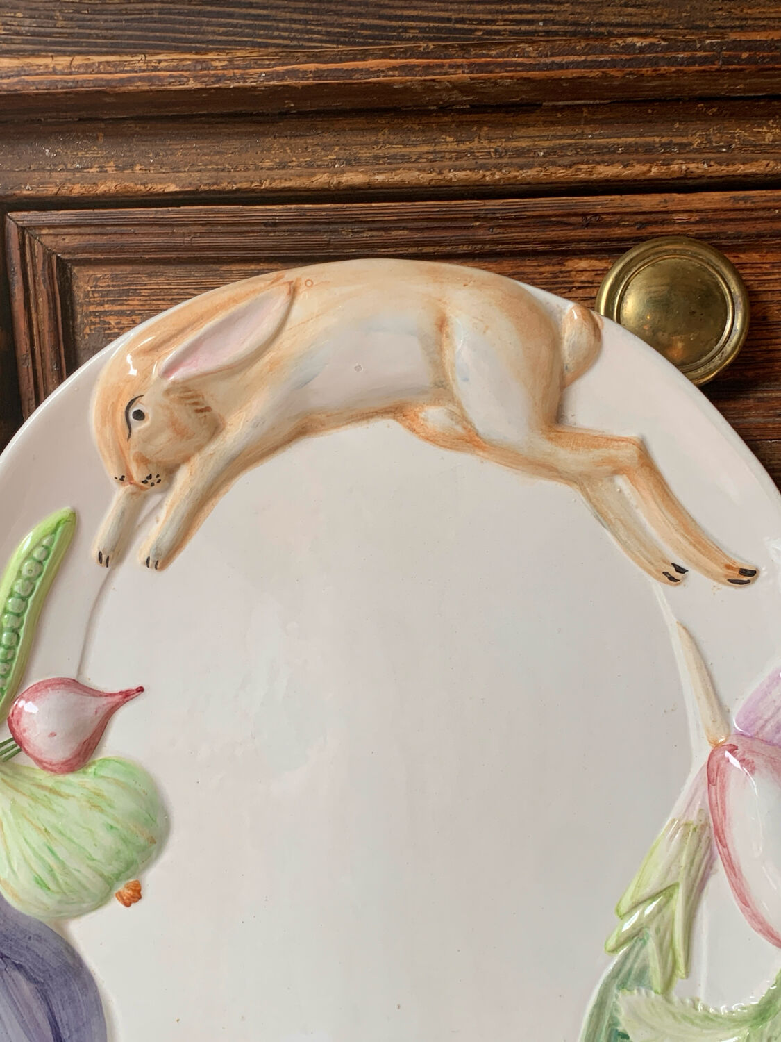 Very large serving dish with hares and vegetables.