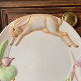 Very large serving dish with hares and vegetables.
