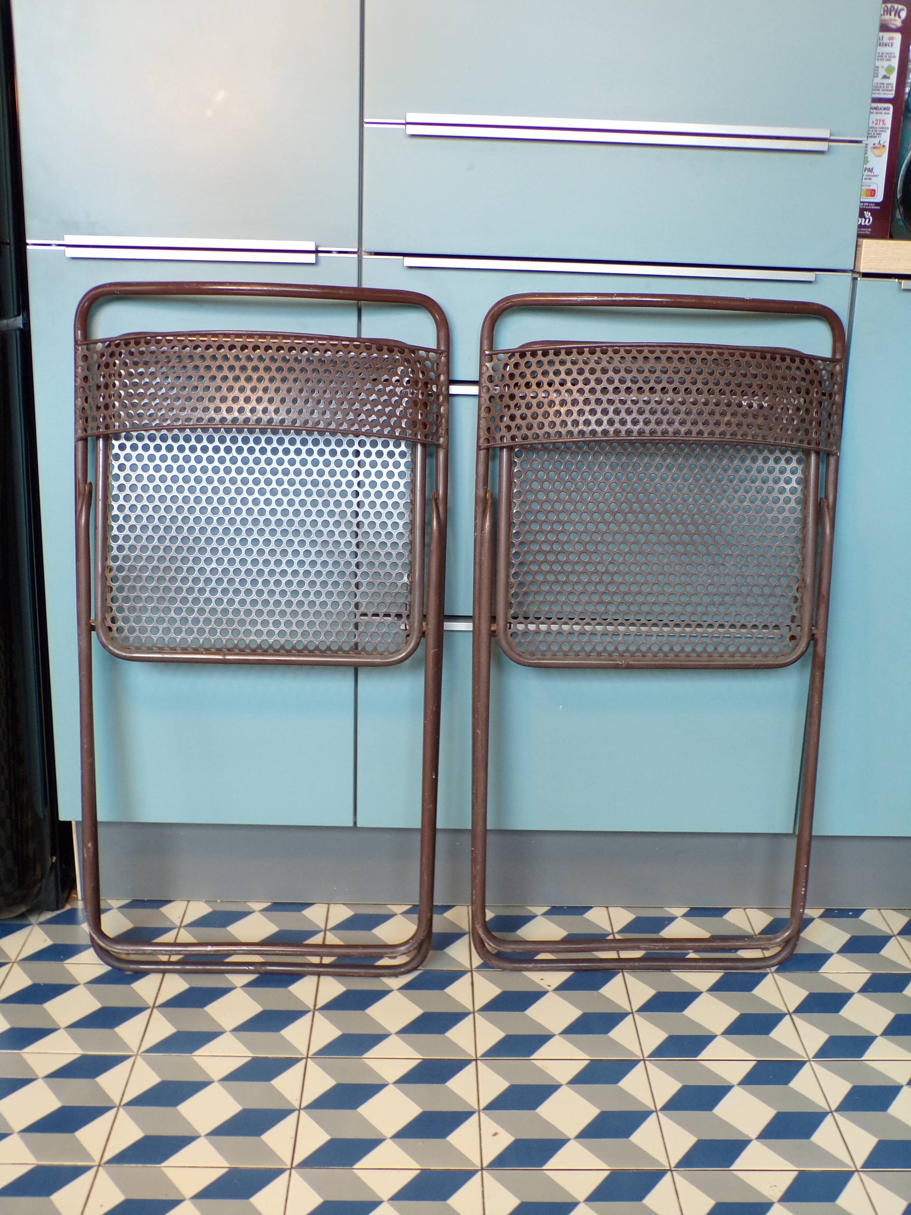Pair of folding chairs in perforated sheet metal