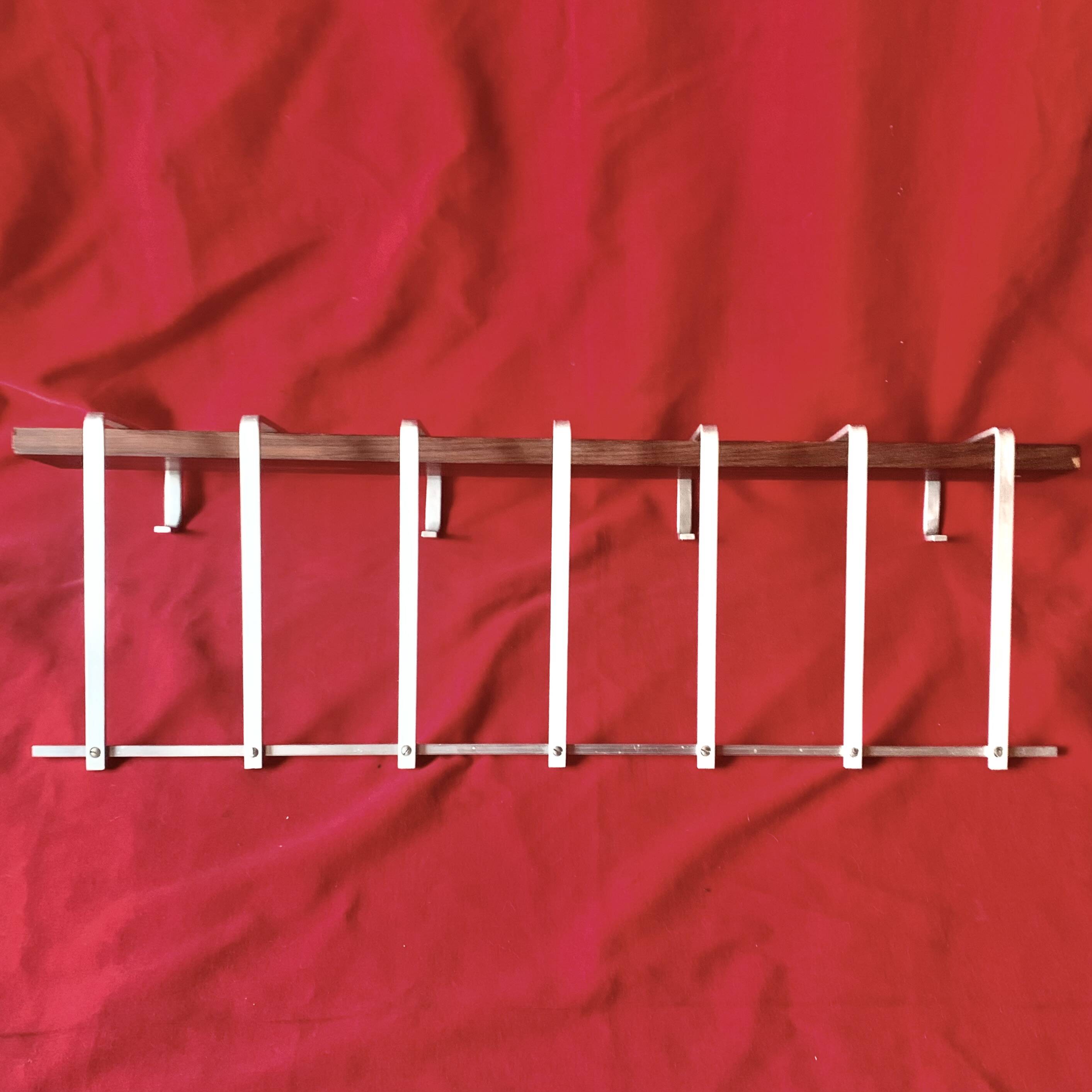 Vintage wall-mounted coat rack made of plywood and aluminum with hat rack