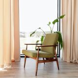 Mid-century modern armchair in olive green bouclé design by H. Lis.