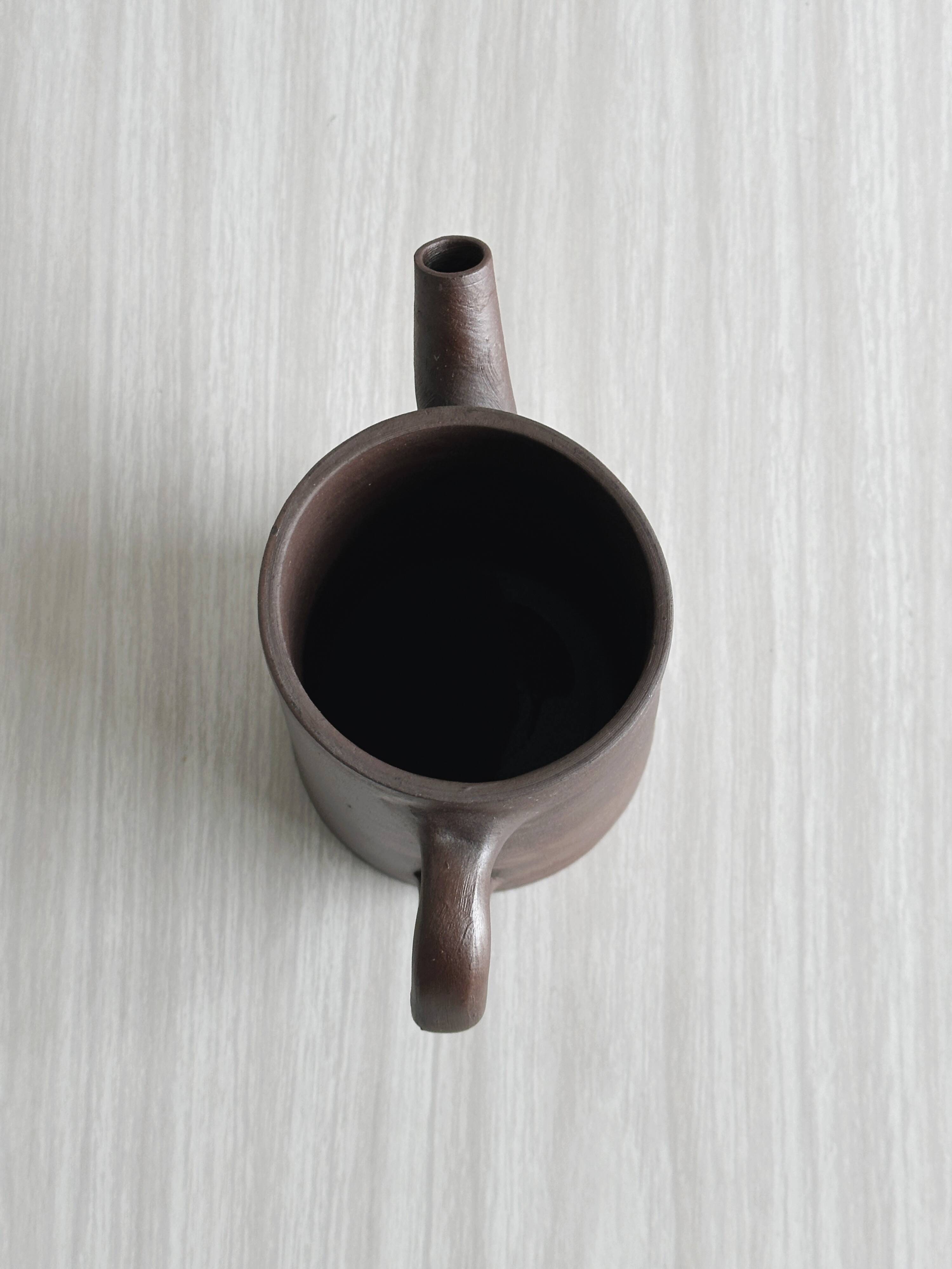 Small pitcher in brown glazed stoneware