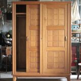 Vintage wooden wardrobe with sliding doors.