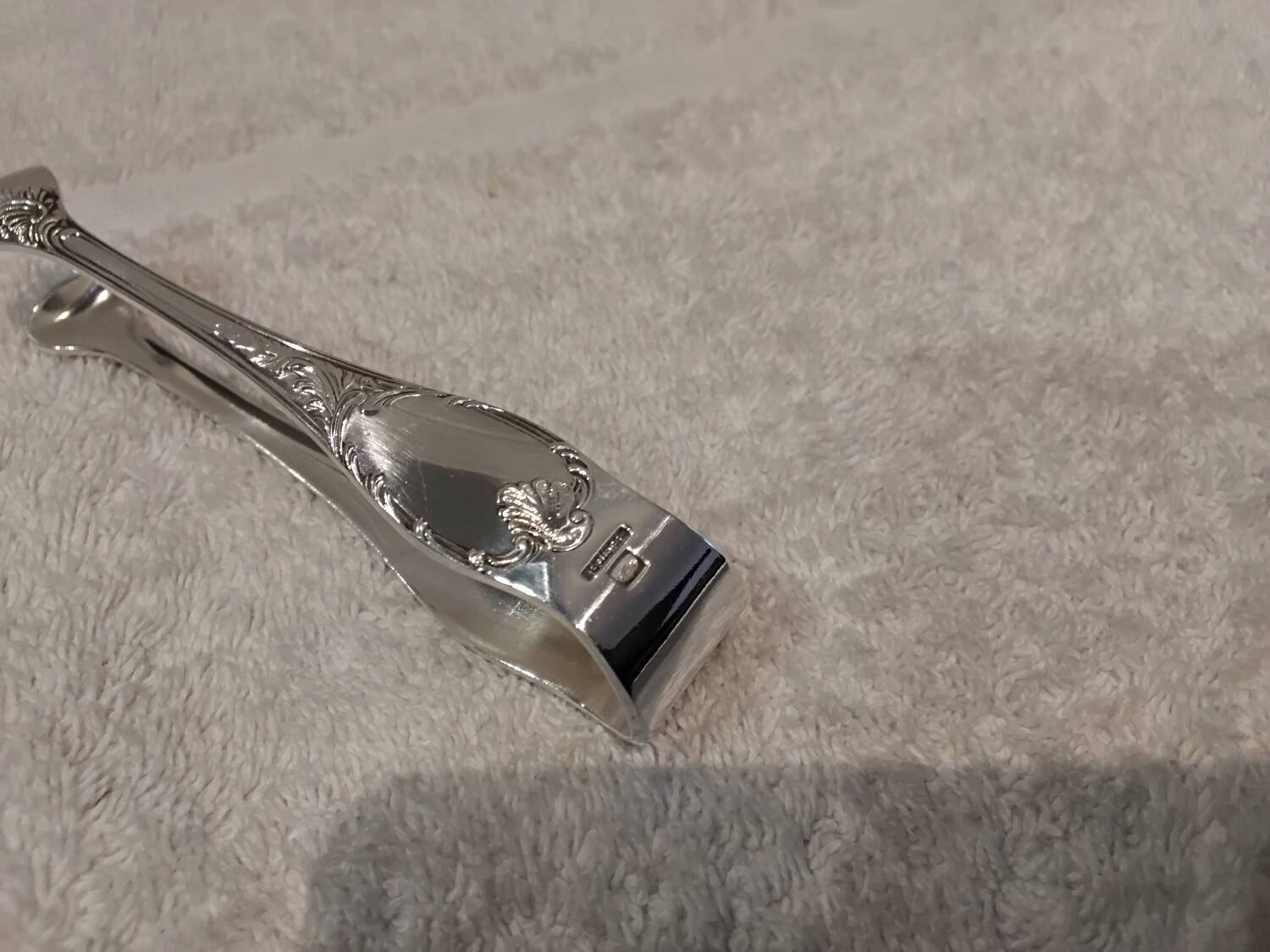 Small silver-plated sugar tongs by Christofle Marly, 11.3 cm