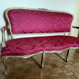 Louis XV style sofa in gilded wood and red pompadour fabric