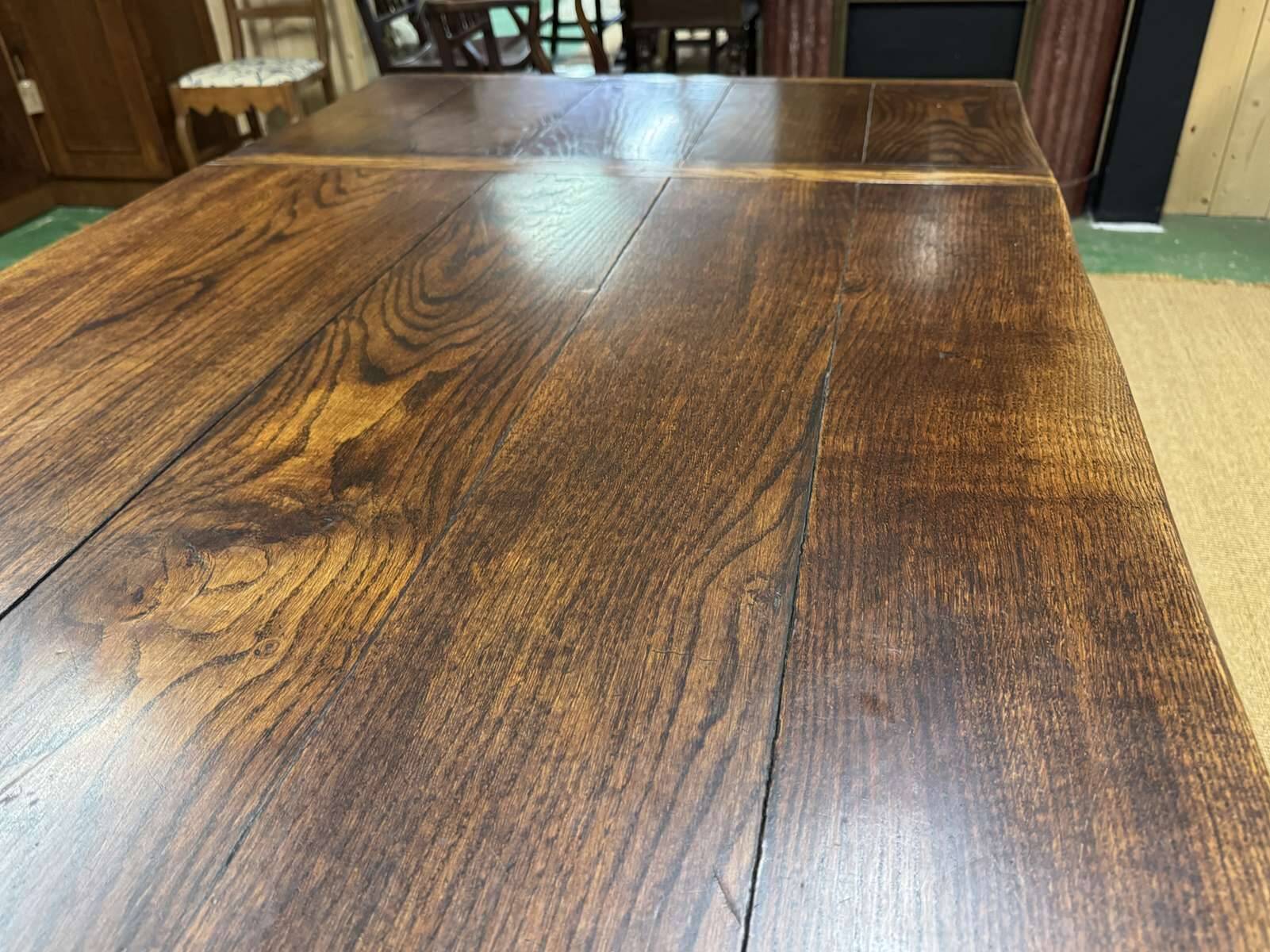 English monastery table with extensions from the late 19th century in elm and oak.