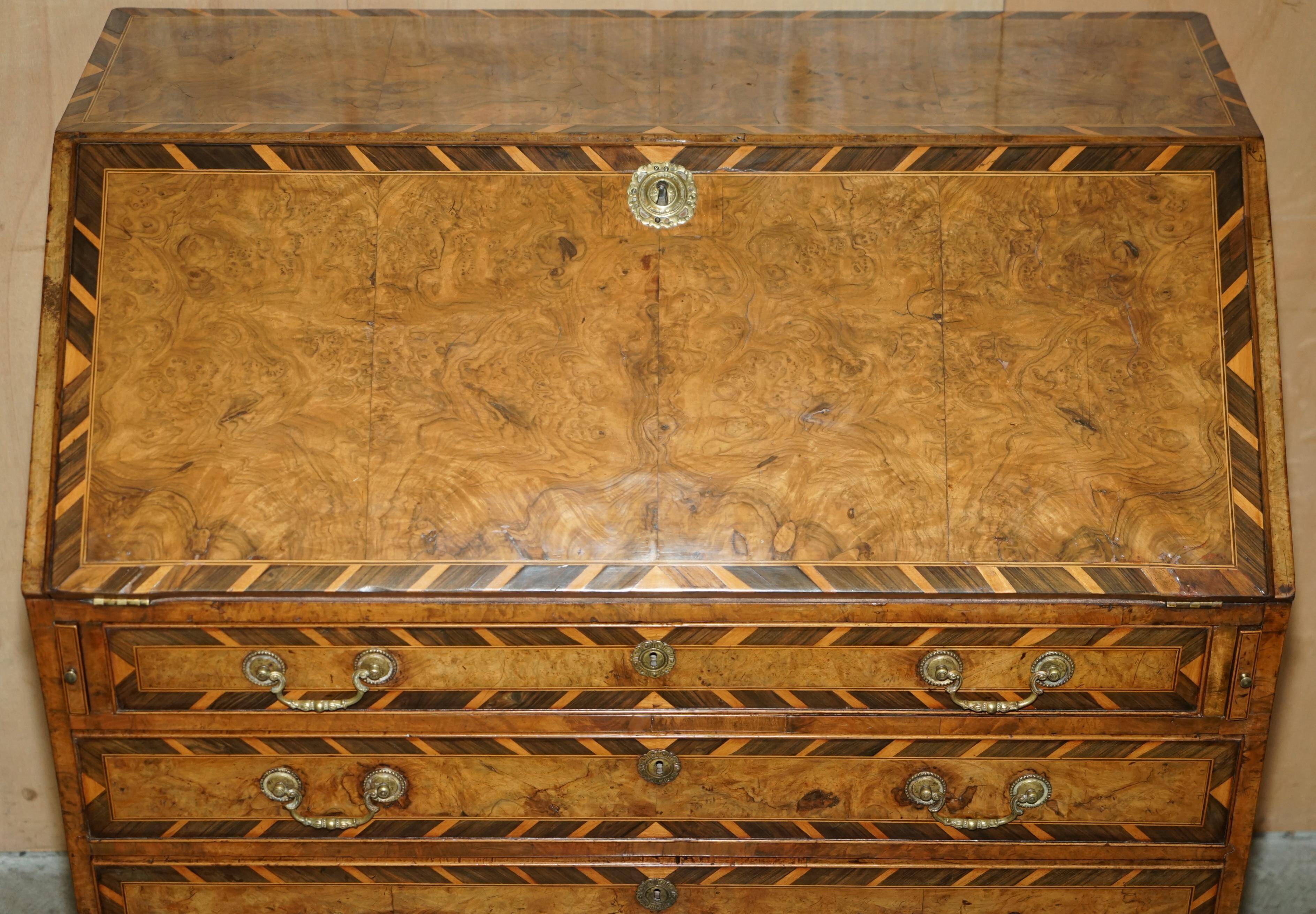 Antique George II bureau from 1740 in walnut, rosewood, and leather.
