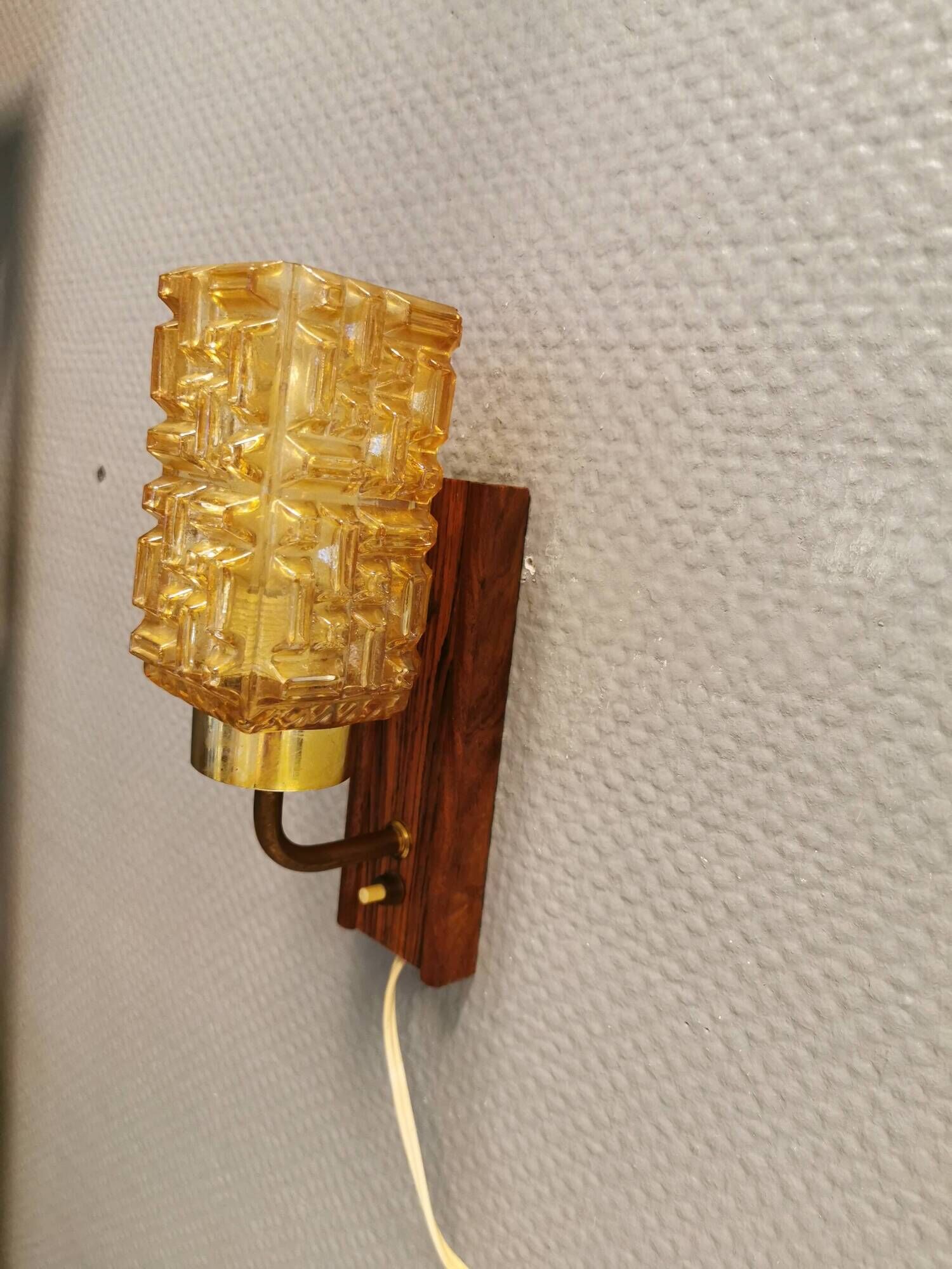 wall lights in rosewood look, with amber coloured glass and brass details.