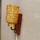 wall lights in rosewood look, with amber coloured glass and brass details.