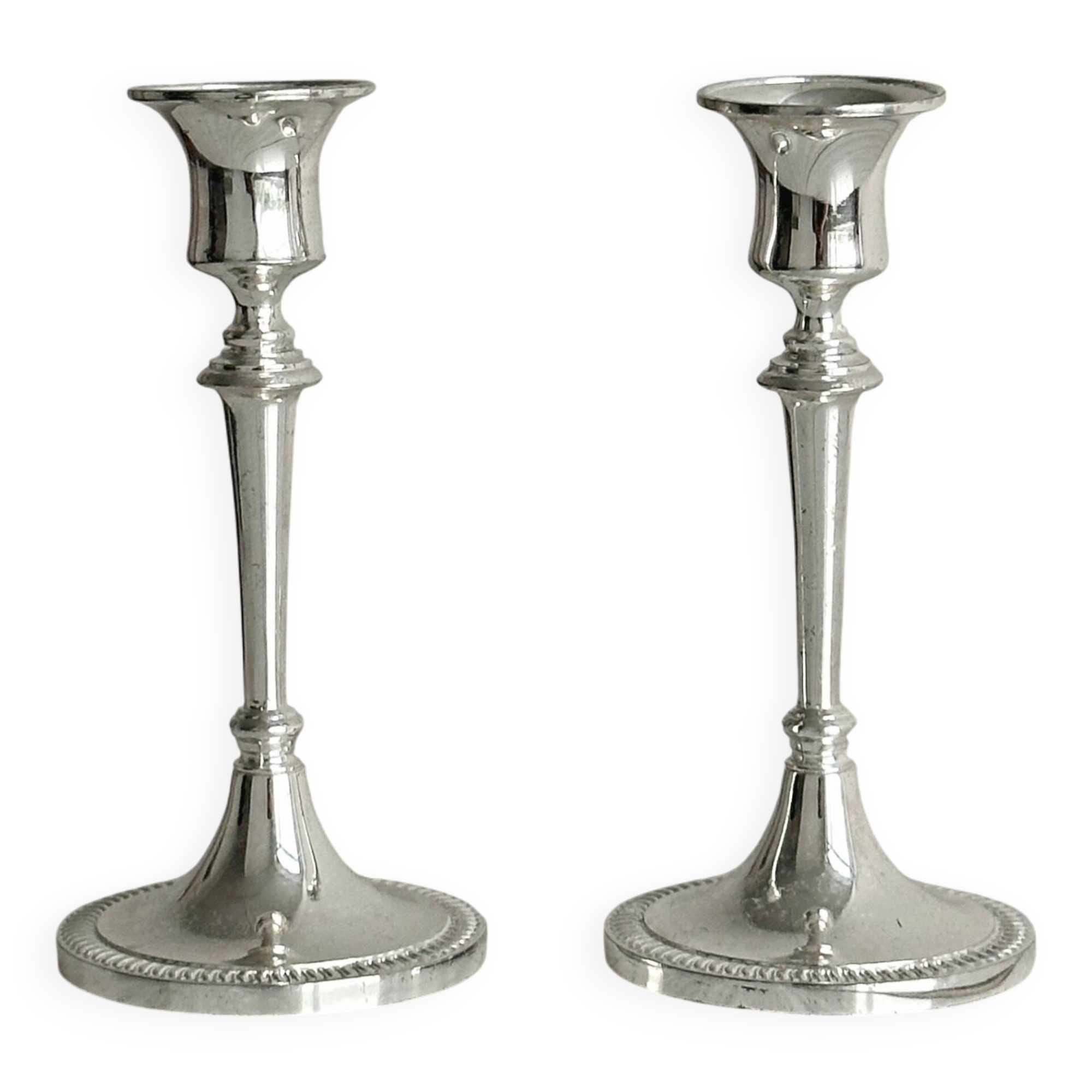 Pair of white metal candlesticks