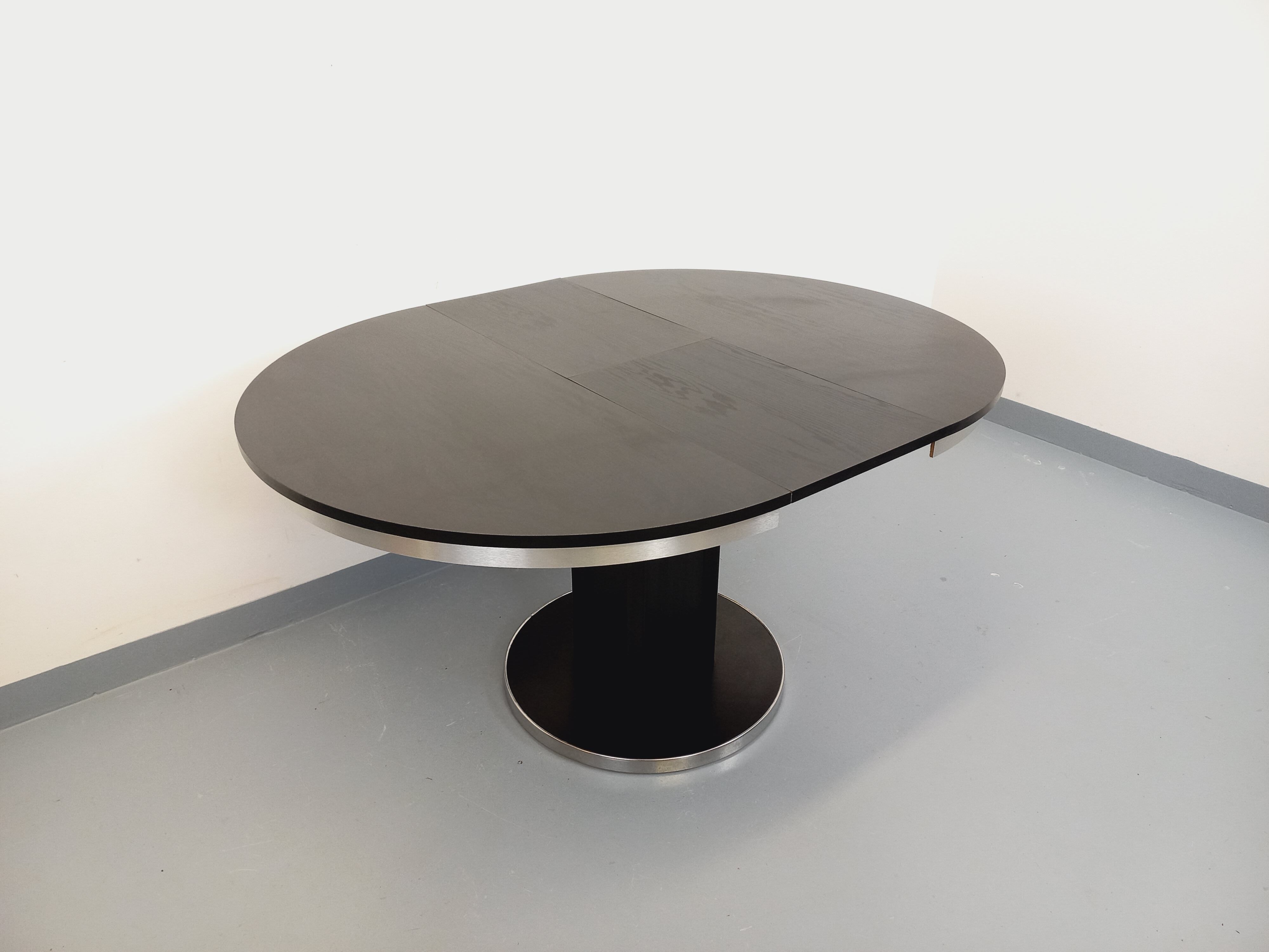 Vintage dining table in melamine with a black wood effect and chrome metal.
