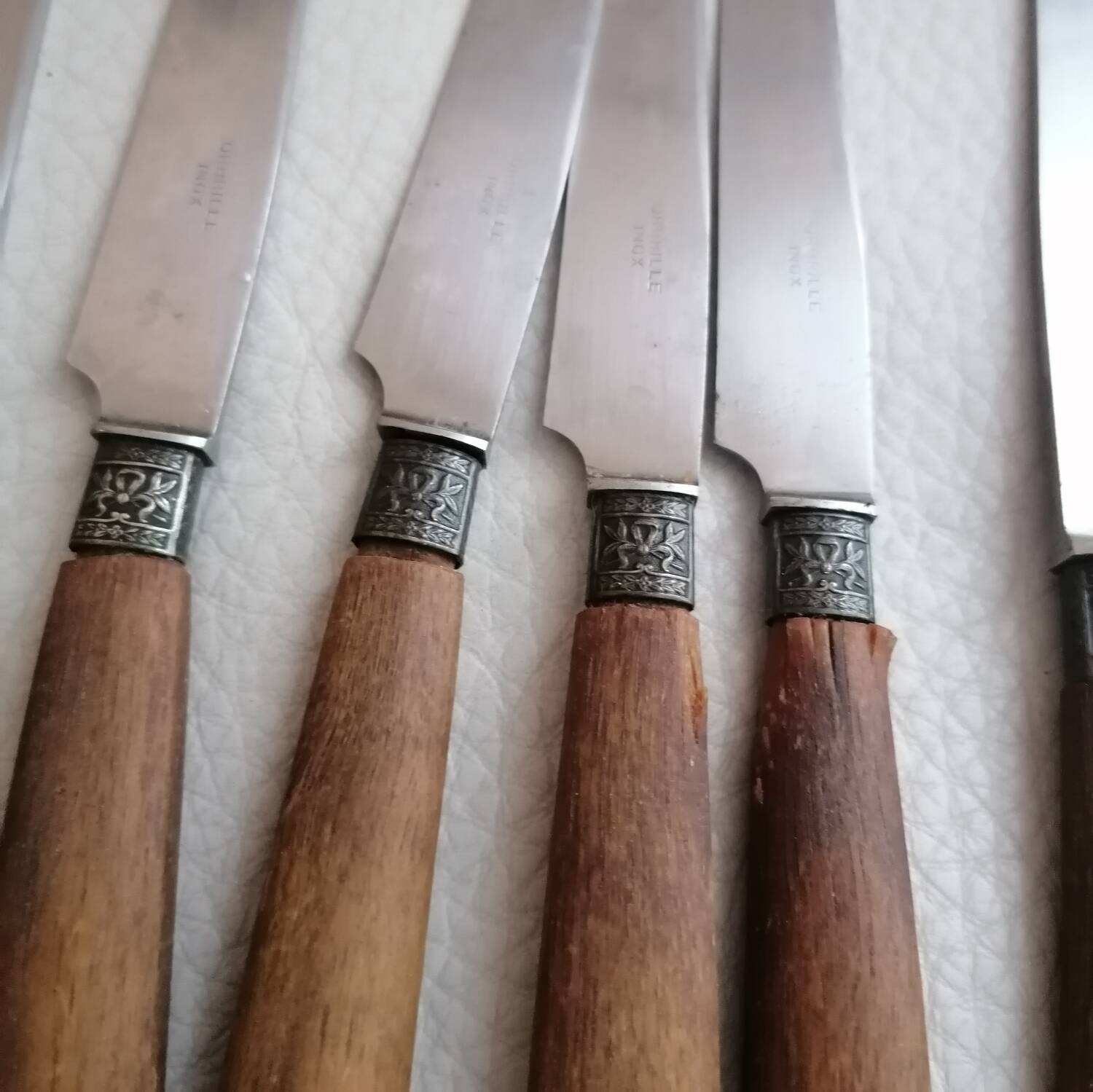 Old table knives and dessert knives, wooden handles, stainless steel blades